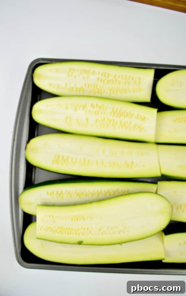 Preparing zucchini sticks on a baking sheet