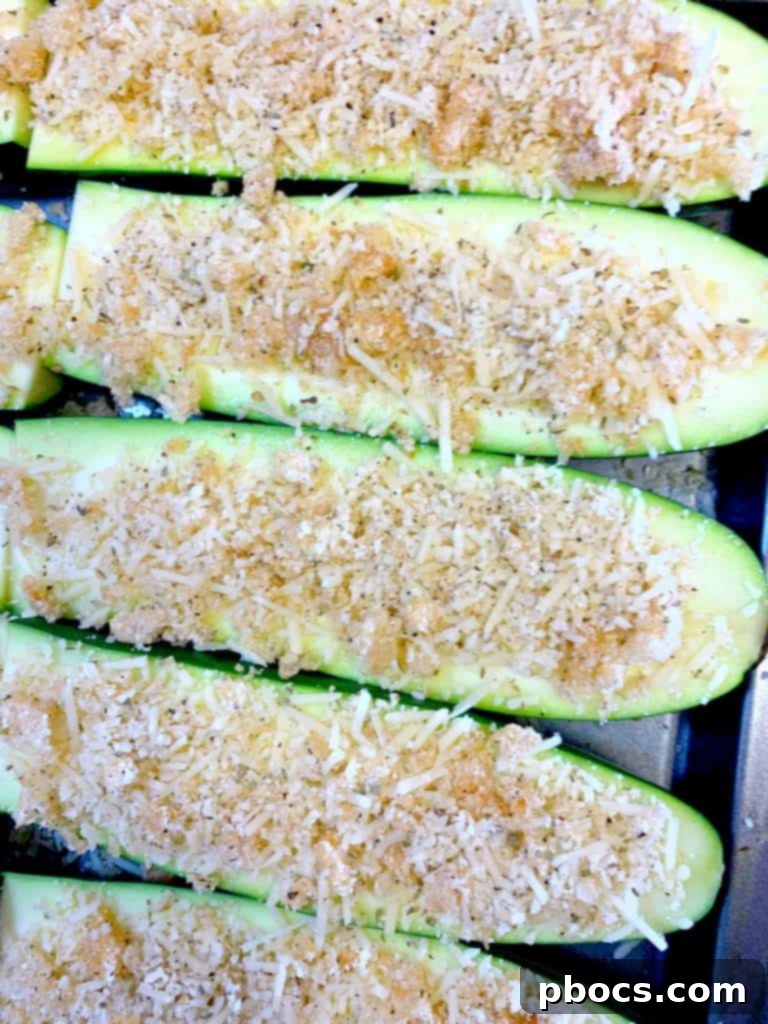 Coating zucchini sticks with parmesan and pork rind mixture