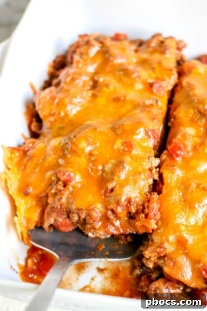 A serving of Low Carb Chili Cheese Dog Bake on a plate with fresh toppings.