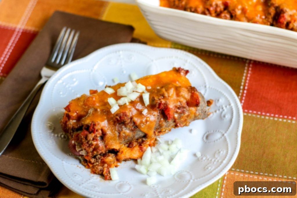 Close-up of a bubbling Low Carb Chili Cheese Dog Bake fresh from the oven, showing the golden cheese topping.