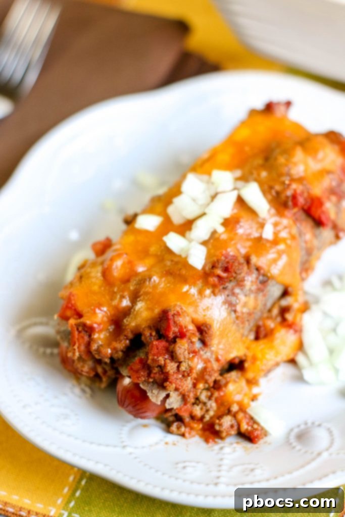Overhead view of a Low Carb Chili Cheese Dog Bake, showcasing the wrapped hot dogs and chili.