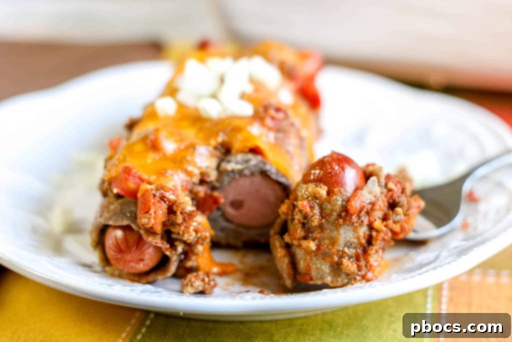 Low Carb Chili Cheese Dog Bake ready for the oven, topped with shredded cheese.