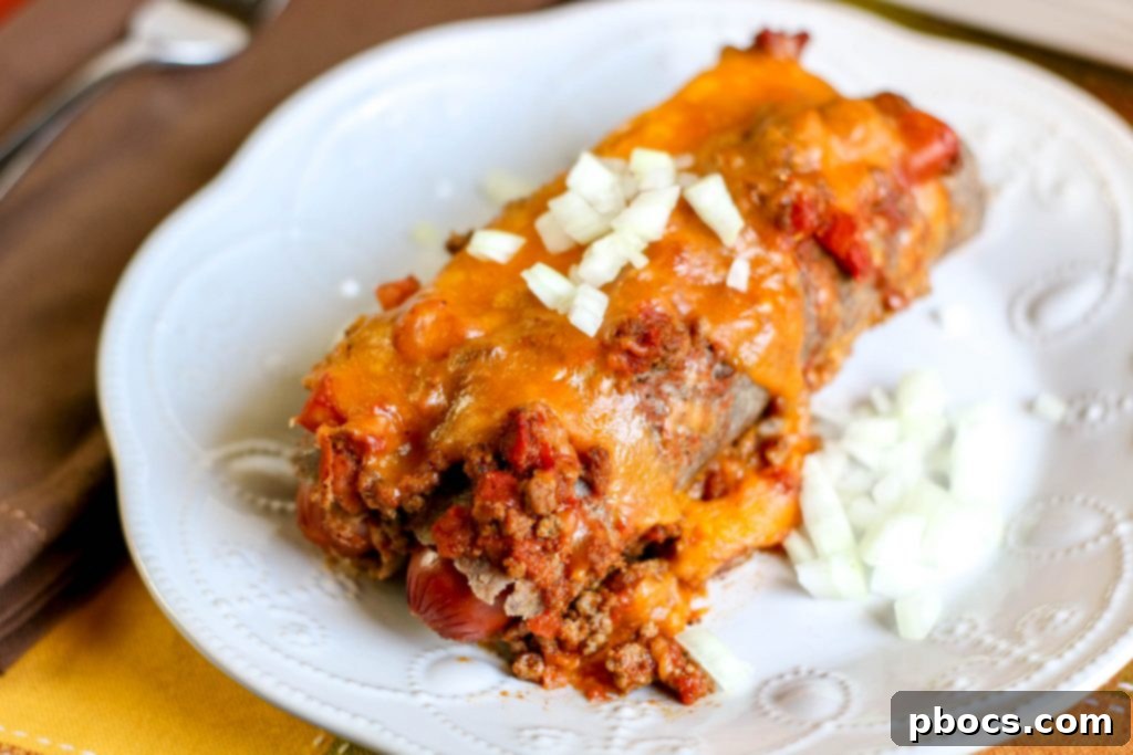Low Carb Chili Cheese Dog Bake, sliced and served with a side of green onion.