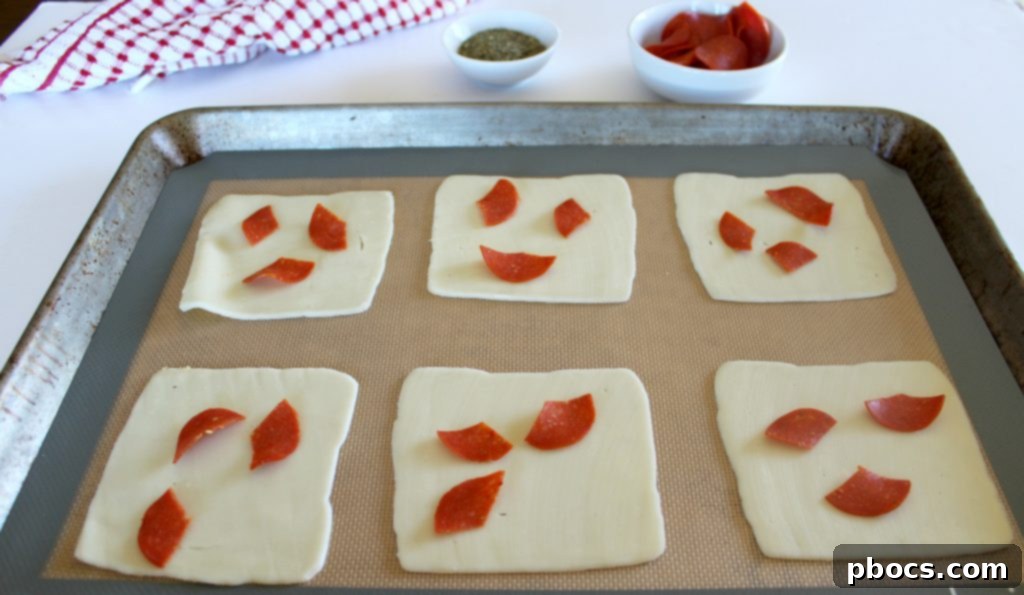 Mozzarella cheese slices laid on a baking mat
