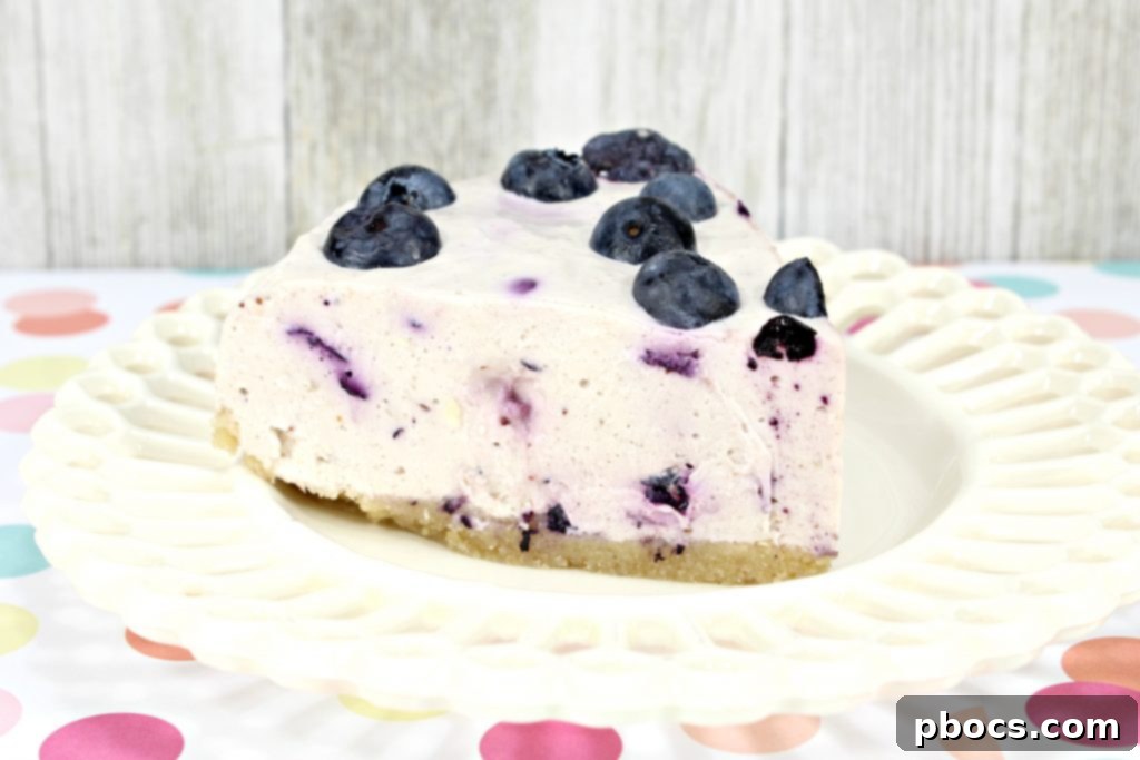 Hands preparing a No Bake Keto Blueberry Cheesecake.