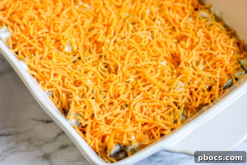 Topping casserole with shredded cheese and pork rinds