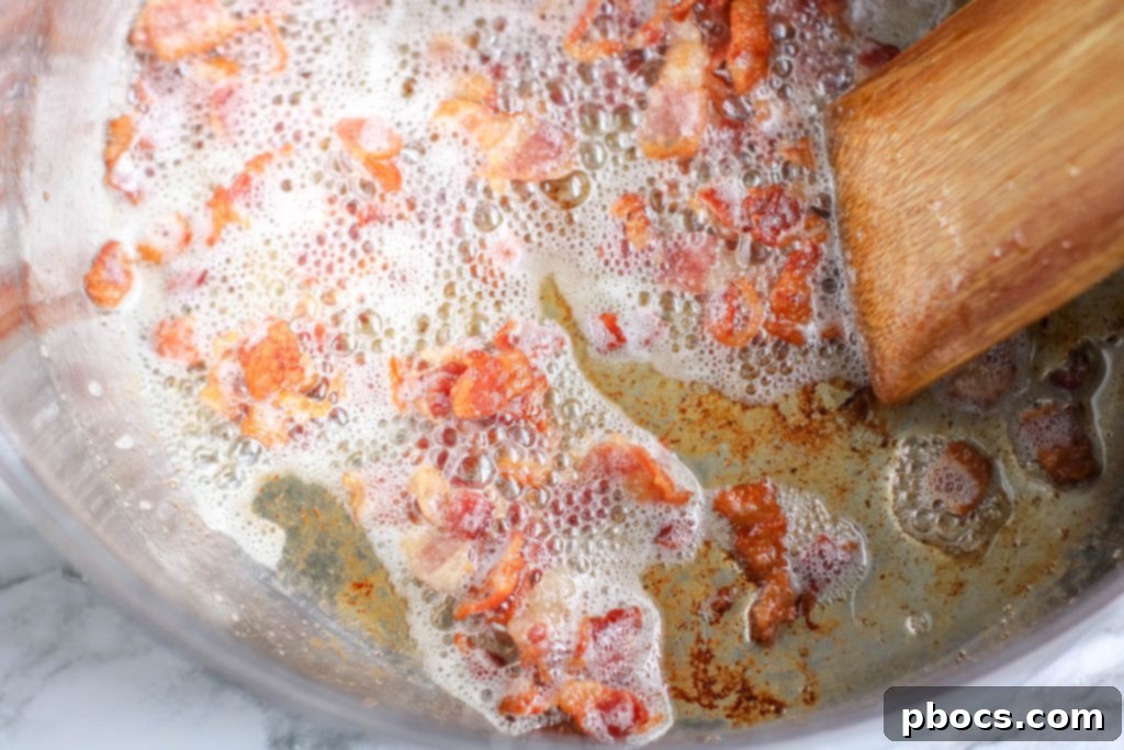 Creamy Keto Bacon Cauliflower Chowder 8 Chowder simmering with cauliflower and broth