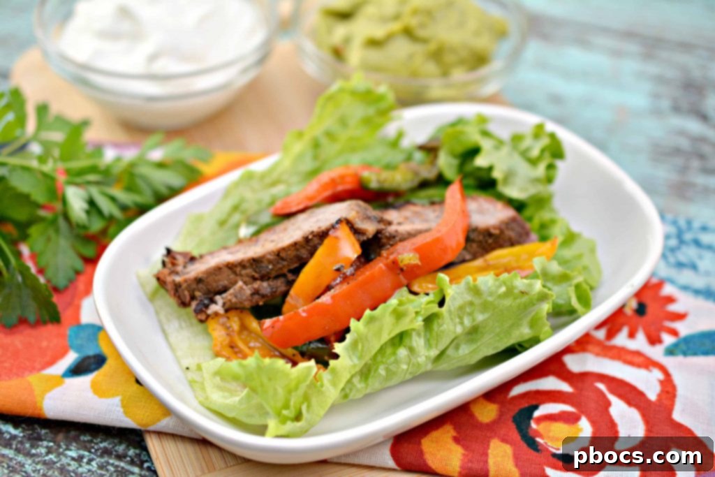 Sizzling Keto Steak Fajita Lettuce Wraps 3 Close-up of sizzling Keto Steak Fajitas with bell peppers and onions in a skillet.
