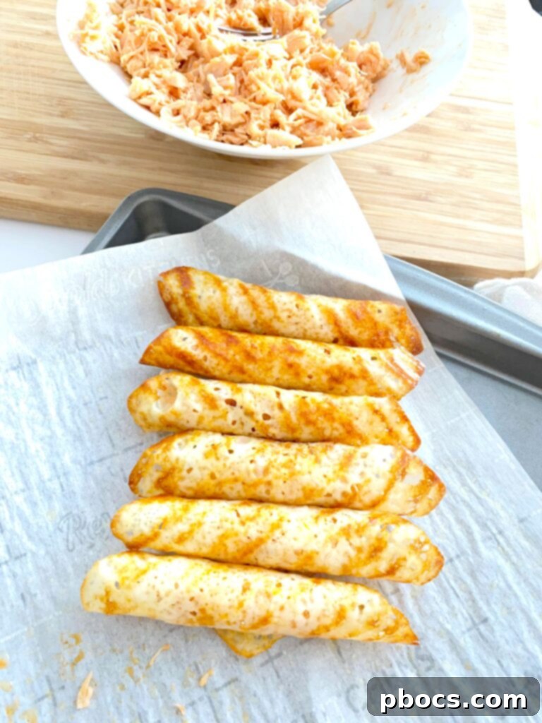 Crispy Keto Buffalo Chicken Taquitos 9 Rolling the cheese with buffalo chicken filling