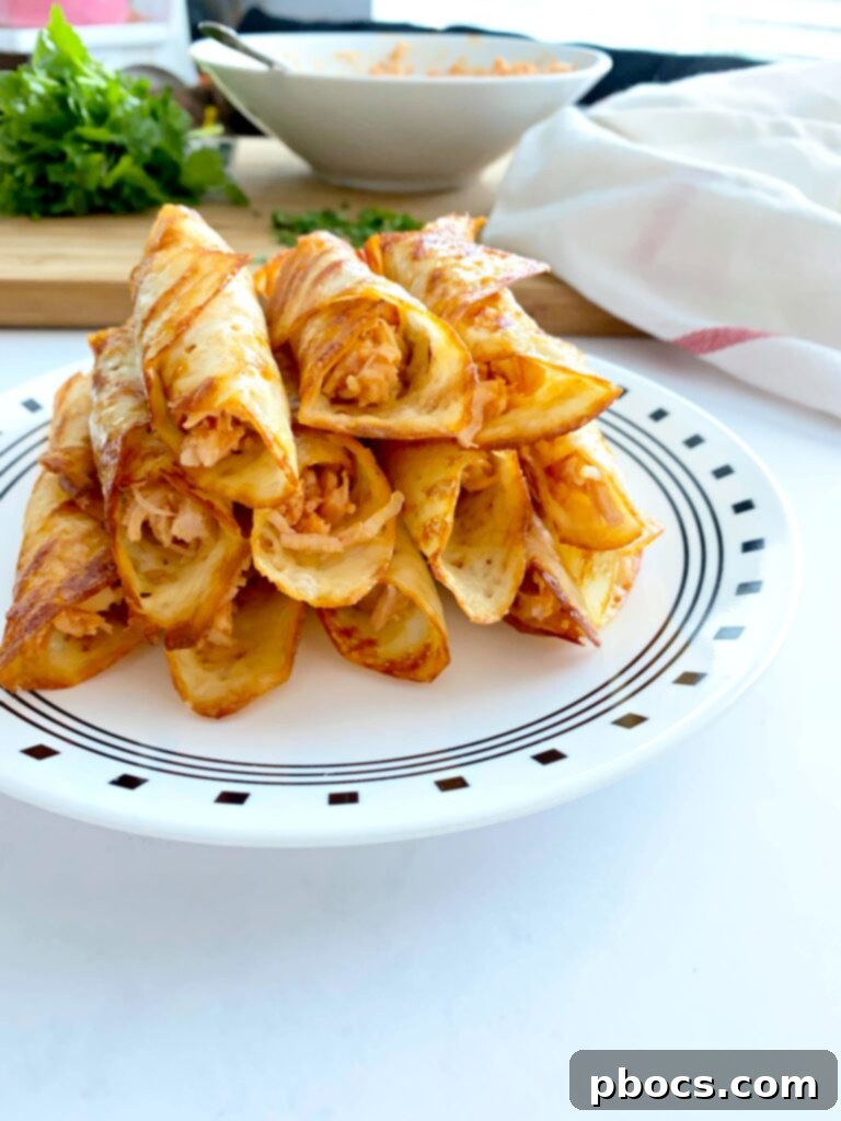 Crispy Keto Buffalo Chicken Taquitos 10 Finished Keto Buffalo Chicken Taquitos on a plate