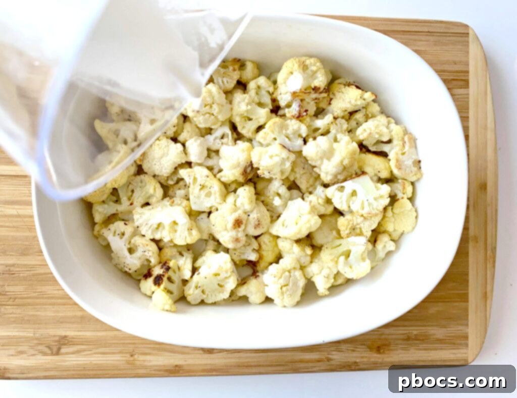 Keto Cheeseburger Cauliflower Bake 7 Roasted cauliflower transferred to a casserole dish with heavy cream and cheese