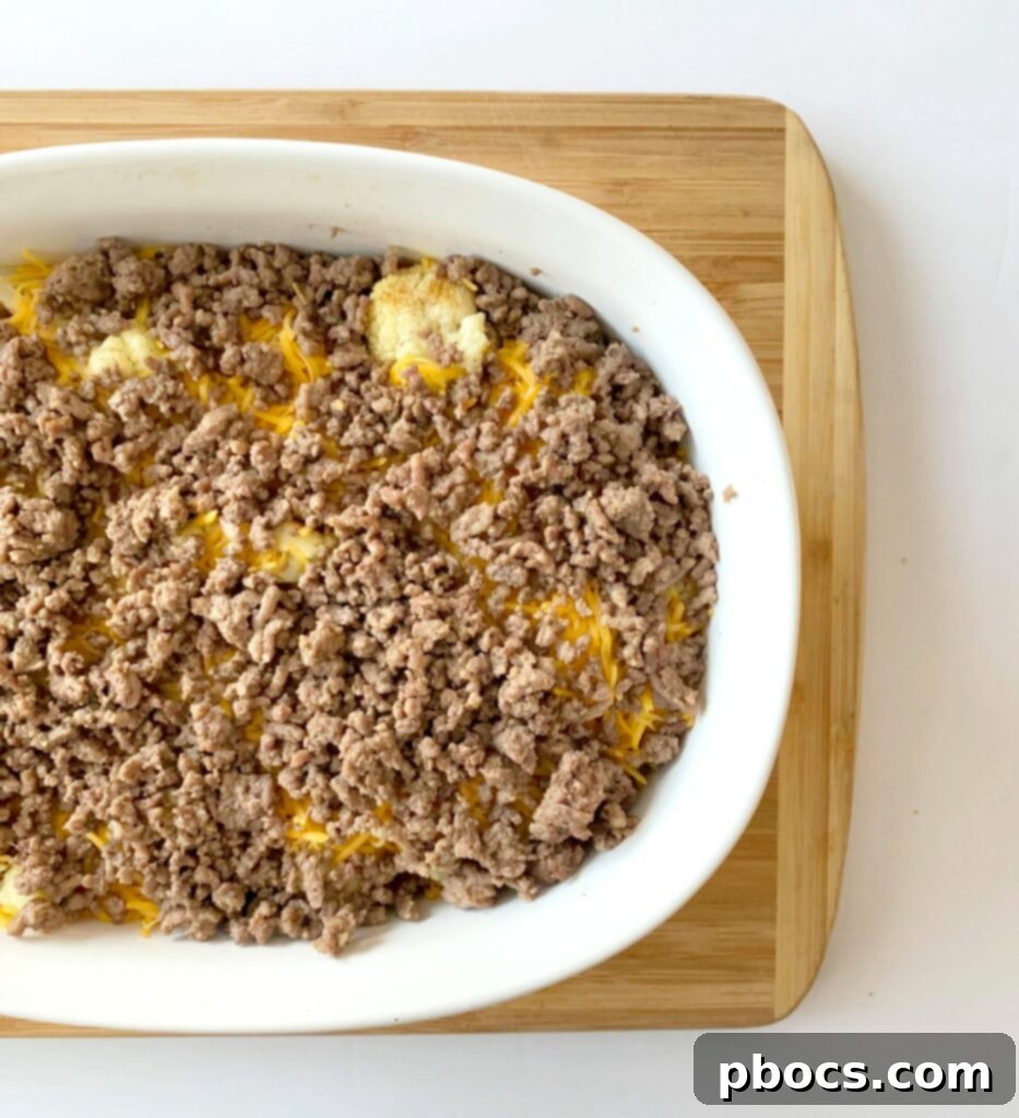 Keto Cheeseburger Cauliflower Bake 9 Keto Cheeseburger Casserole topped with sugar-free ketchup, cheese, and bacon before final bake