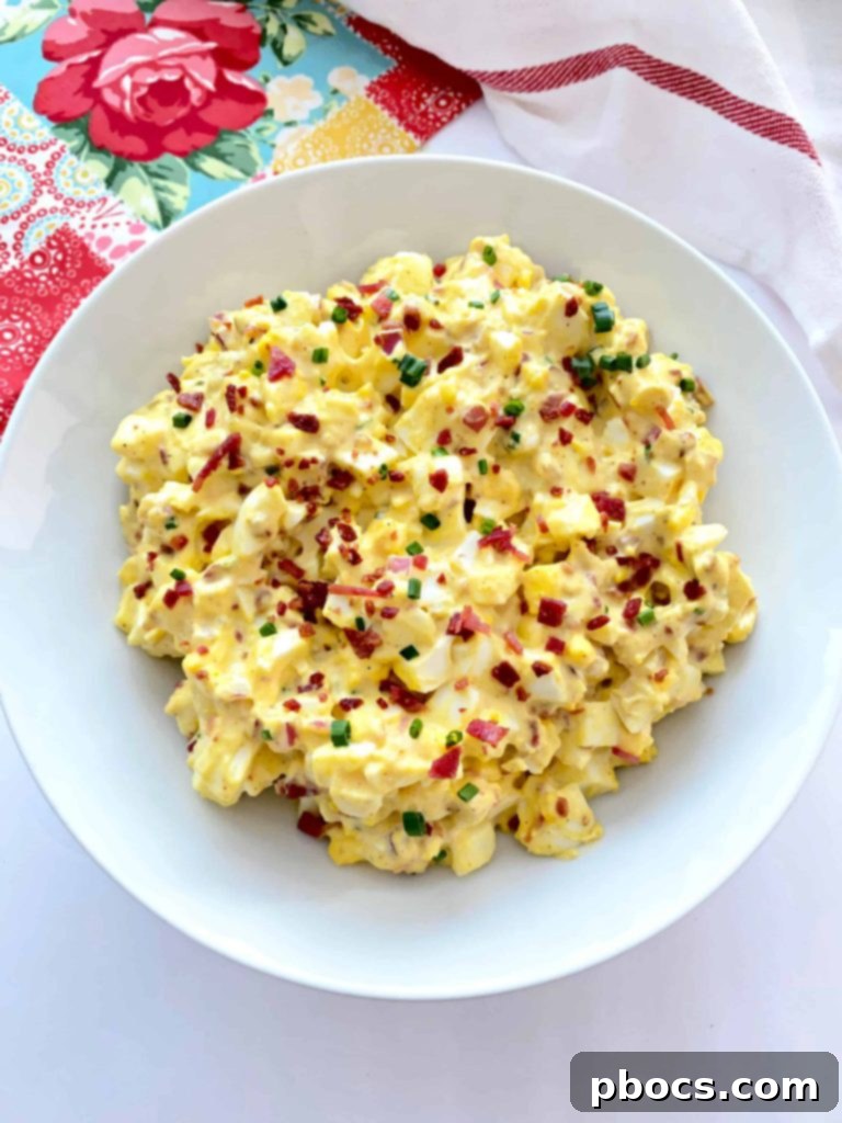 Creamy Keto Deviled Egg Salad served in a bowl, garnished with paprika and chives.