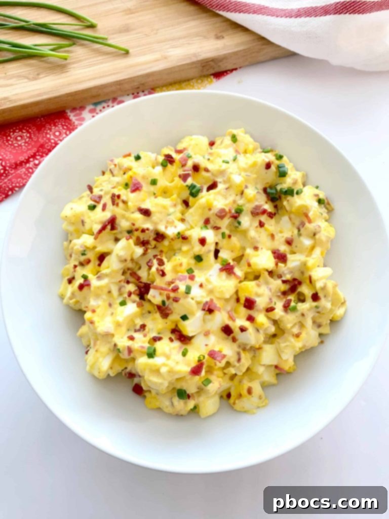 Ingredients for Keto Deviled Egg Salad laid out, including hard-boiled eggs, mayonnaise, mustard, and spices.