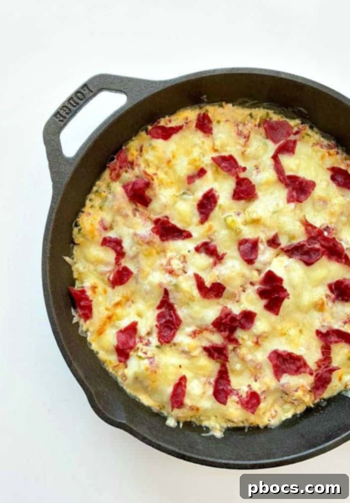 Close-up of baked Keto Reuben Dip with melted Swiss cheese
