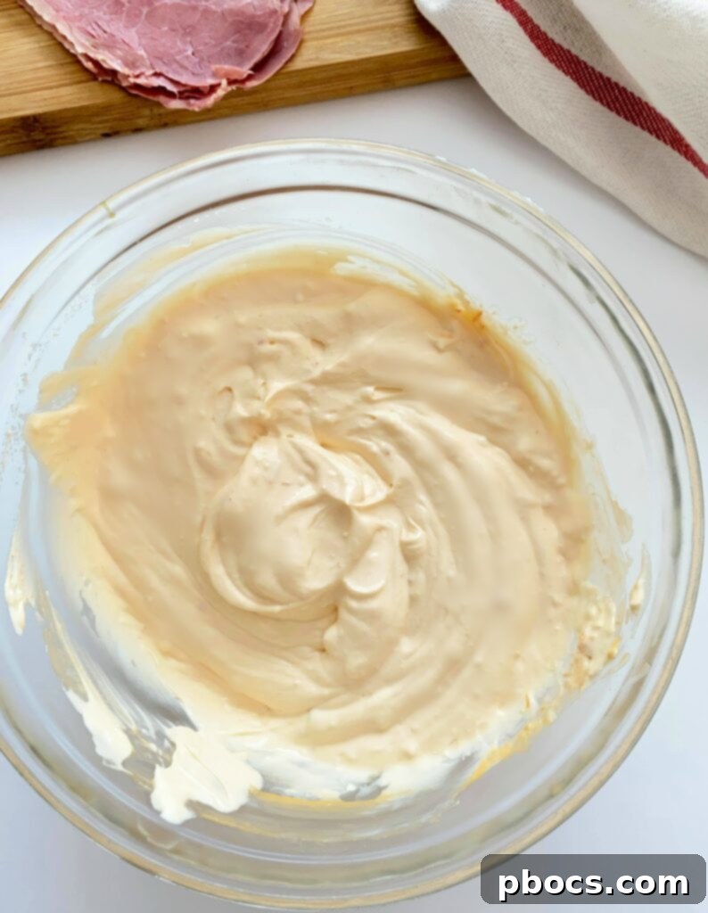 Mixing cream cheese, sour cream, and Russian dressing