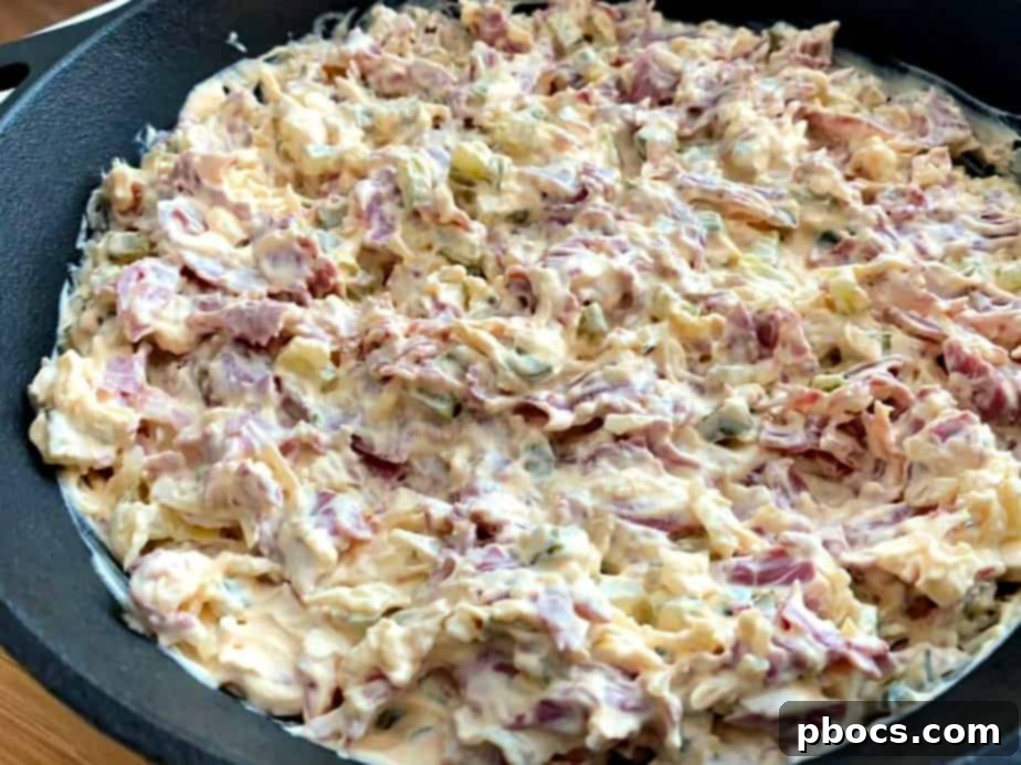 Adding sauerkraut, pickles, and corned beef to the mixture