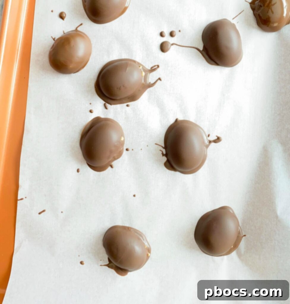 Guilt-Free Keto Chocolate Easter Eggs 7 Coating Keto Peanut Butter Easter Eggs in melted dark chocolate.