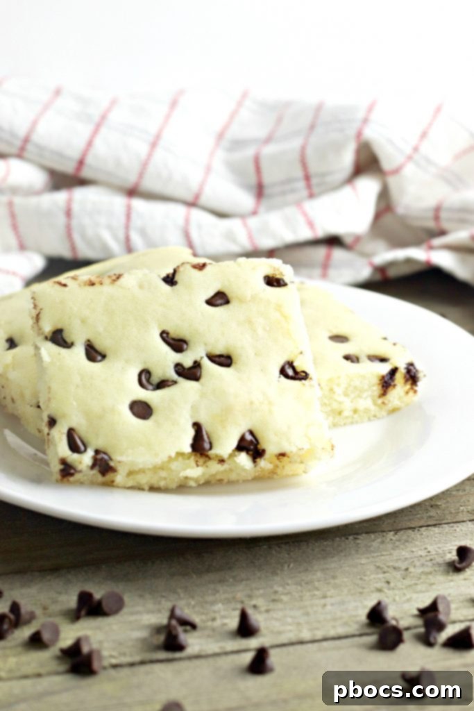 Delicious Keto Sheet Pan Pancakes garnished with fresh berries and a drizzle of sugar-free syrup, ready to be served from the sheet pan.