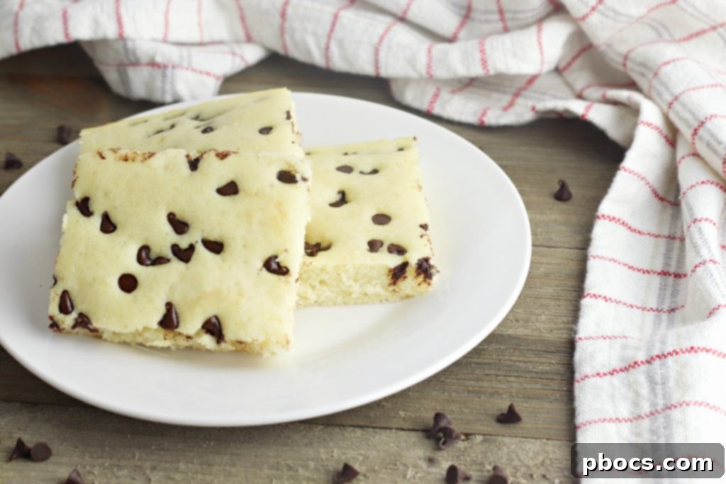 Close-up shot of fluffy Keto Sheet Pan Pancakes topped with melted sugar-free chocolate chips, still in the baking sheet.