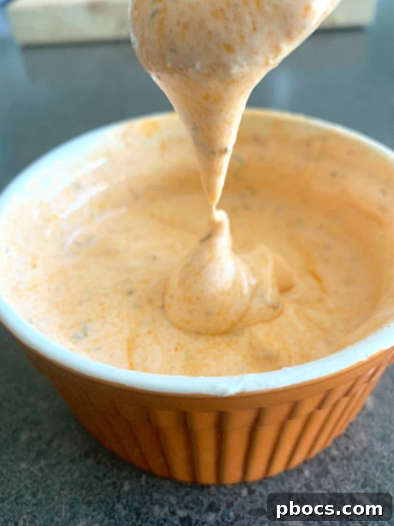 Finished Low Carb Buffalo Chicken Salad, drizzled with creamy dressing and garnished with parsley.