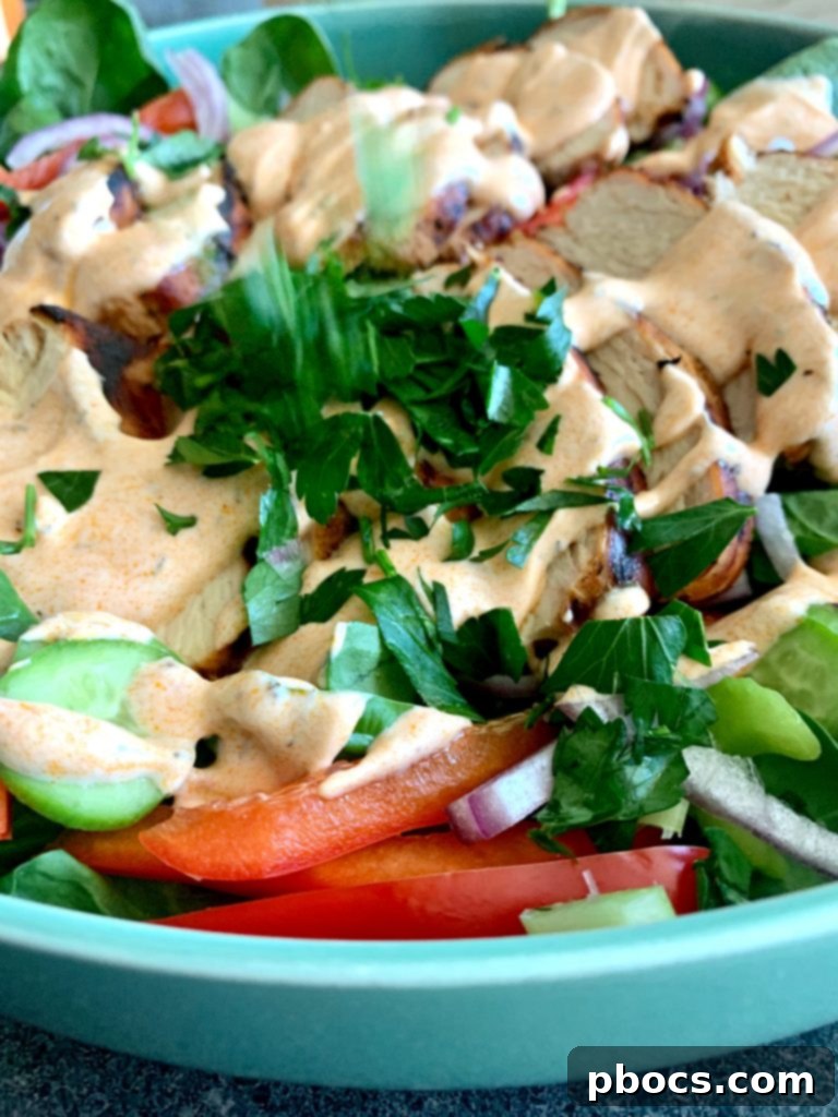 Meal prep containers with grilled buffalo chicken and fresh vegetables, ready for a week of healthy low-carb lunches.
