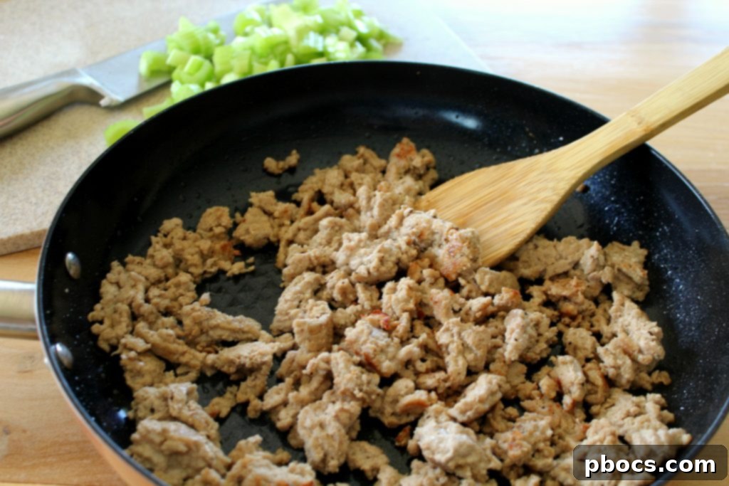 Ground meat browning in a skillet with spices for Keto Dirty Cauliflower Rice