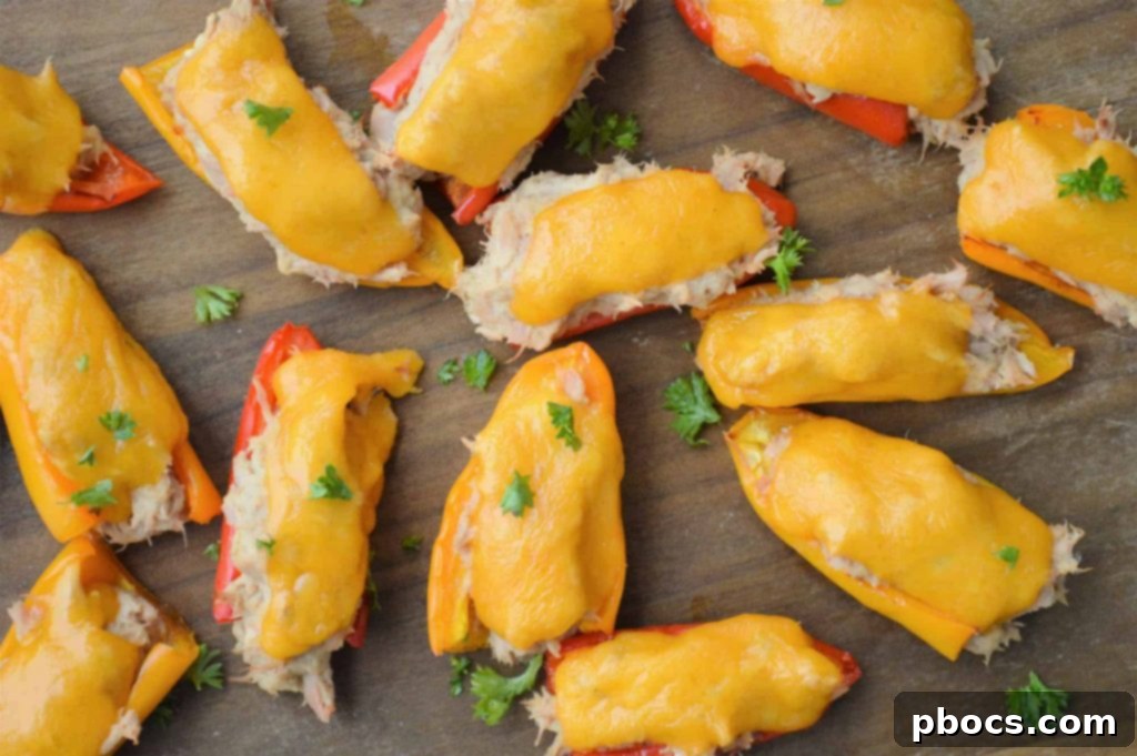 Cheesy Keto Tuna Poppers 3 Close-up of baked Keto Tuna Melt Poppers in bell pepper halves.