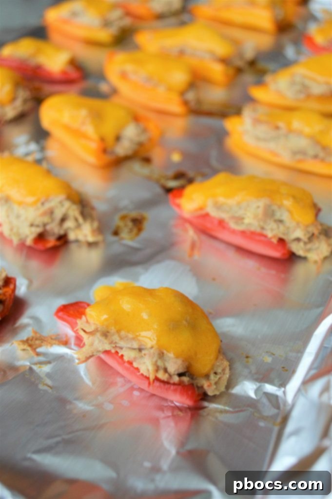 Cheesy Keto Tuna Poppers 9 Bell pepper halves pre-baking on a sheet.