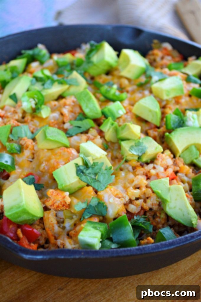 Melted shredded Mexican cheese blanketing the top of the Keto Turkey Mexican Skillet, creating a gooey, irresistible layer.