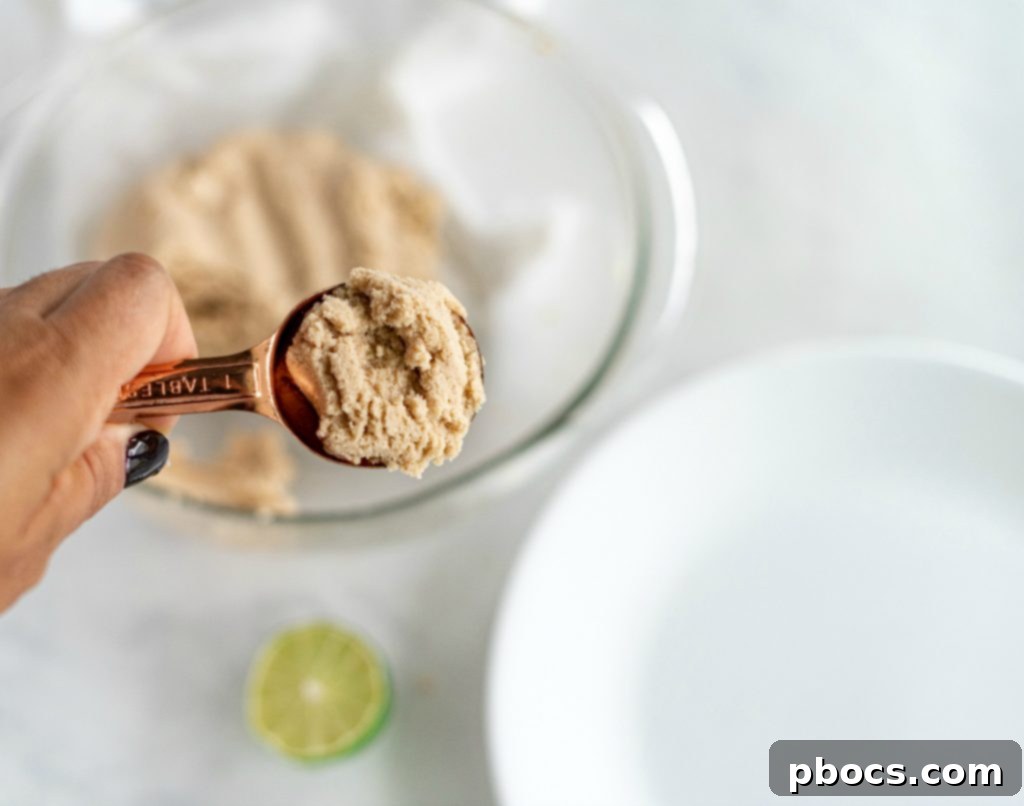 Refreshing Keto Key Lime Fat Bombs 11 Hands in the process of rolling the chilled dough into individual Keto Key Lime Fat Bombs.