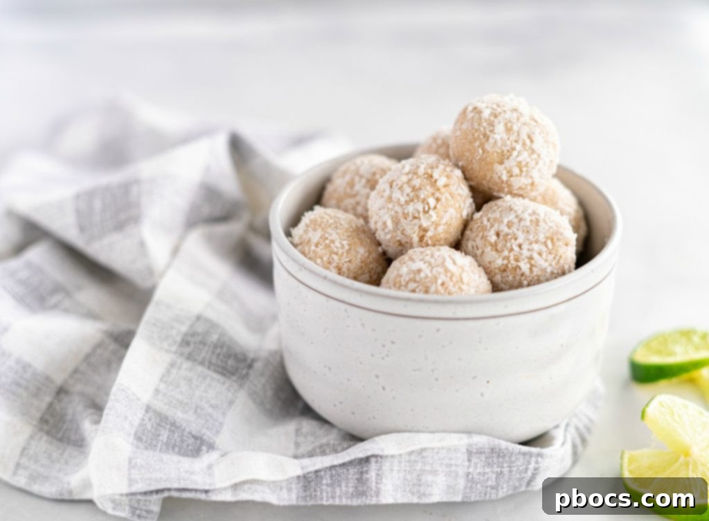 Refreshing Keto Key Lime Fat Bombs 3 A close-up of a stack of Keto Key Lime Fat Bombs, highlighting their appealing texture and a garnish of fresh lime zest.