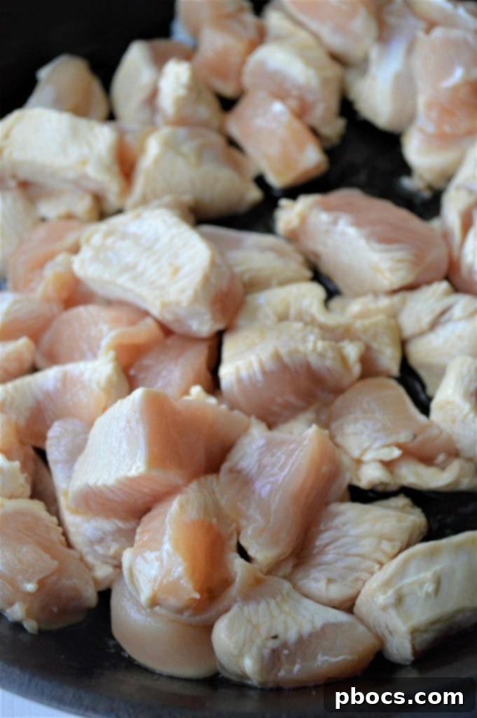 Cooking chicken in a skillet for Keto Cauliflower Chicken Fried Rice