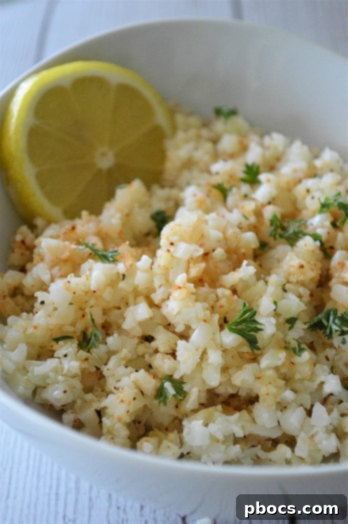 Flavorful Garlic Butter Cauliflower Rice 3 Garlic Butter Cauliflower Rice cooking in a skillet.