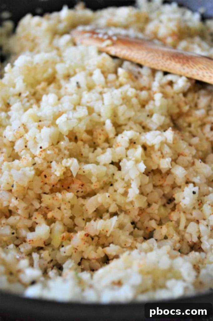 Flavorful Garlic Butter Cauliflower Rice 8 Minced garlic sizzling in butter in a skillet.