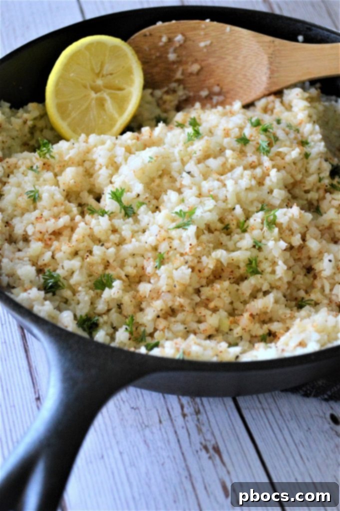 Flavorful Garlic Butter Cauliflower Rice 9 Cauliflower rice, salt, pepper, and chili powder cooking in a skillet.