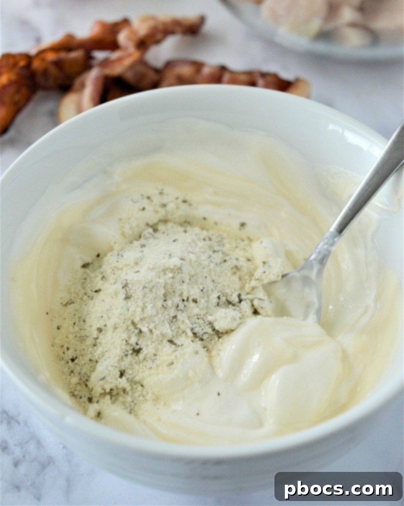 Mixing cream cheese, sour cream, mayo, and ranch seasoning