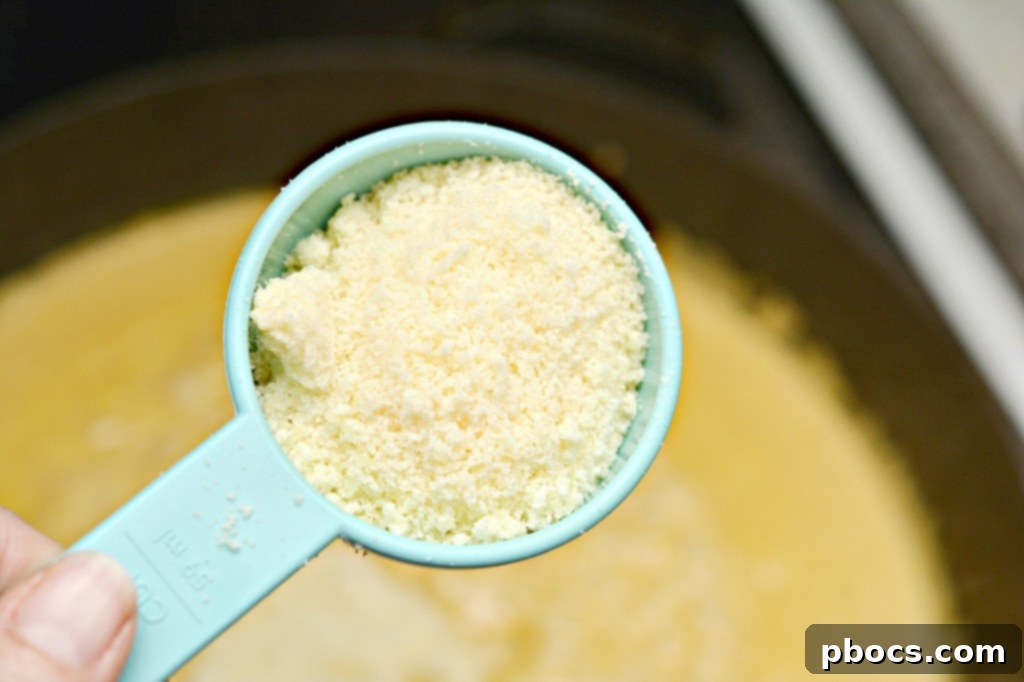 Step 7: Mixing parmesan cheese into the pumpkin alfredo sauce