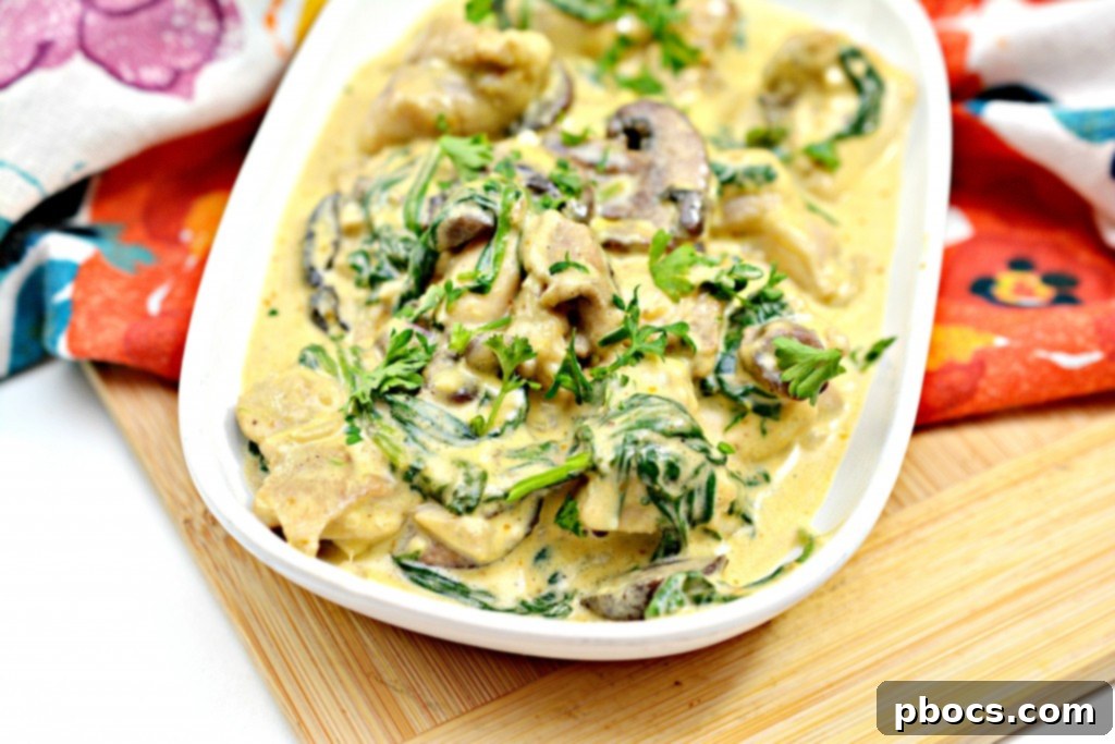 Close-up of creamy Low-Carb Chicken Pumpkin Alfredo in a skillet