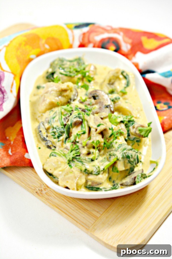 Low-Carb Chicken Pumpkin Alfredo with fresh herbs as garnish