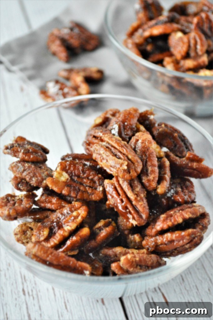 Keto Candied Pecan Bliss 2 Keto Candied Pecans Recipe - A close-up shot of perfectly candied pecans, glistening and ready to eat, arranged artfully on a white surface.