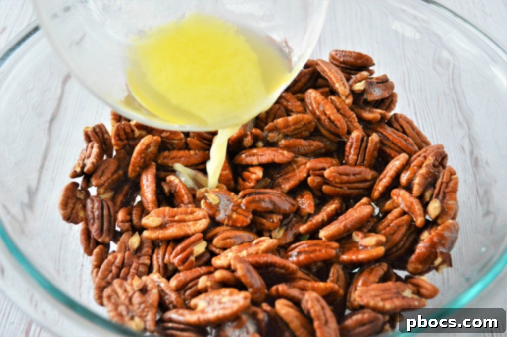 Keto Candied Pecan Bliss 9 Egg white being vigorously whisked in a bowl until it forms light, frothy bubbles.