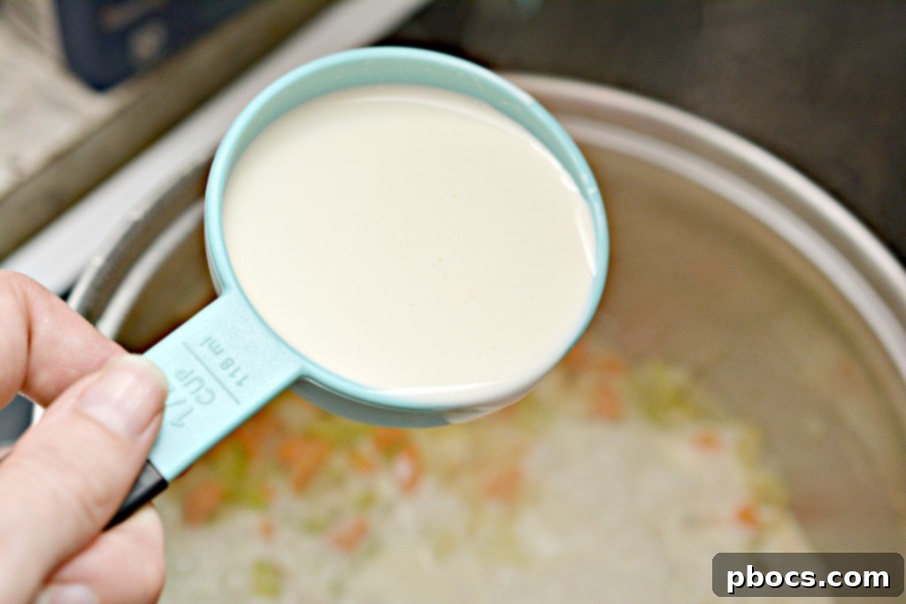 Whisking cream and broth to thicken the pot pie sauce