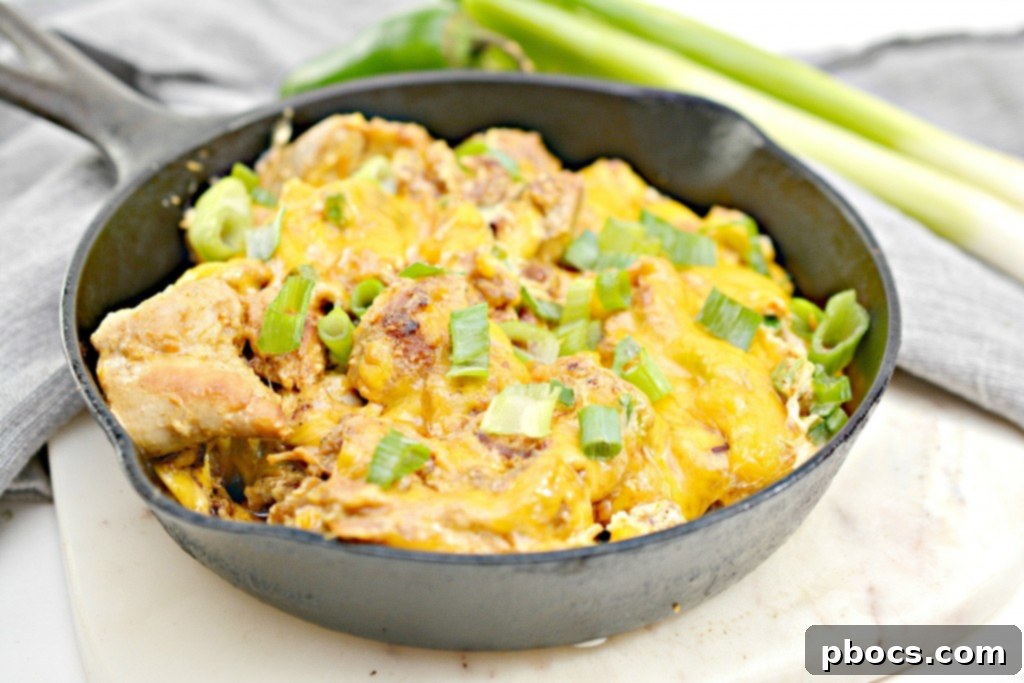 Keto Jalapeno Popper Chicken Skillet 3 Close-up of golden-brown chicken pieces in a skillet, coated in spices and ready for the creamy cheese mixture