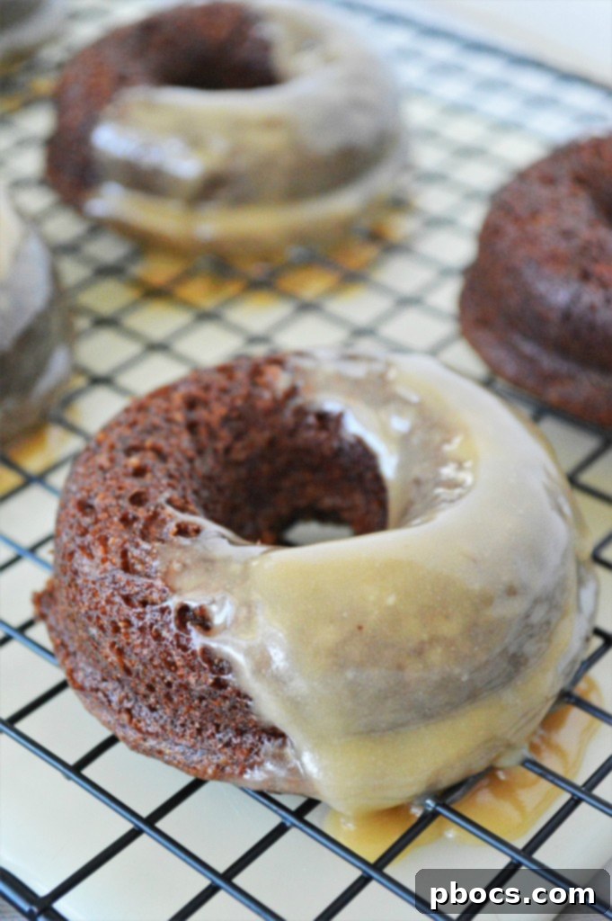 Sprinkling cinnamon sugar on keto gingerbread donuts