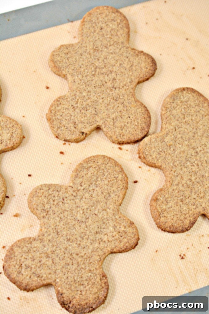 Festive Keto Gingerbread Snaps 11 Cutting out gingerbread shapes from keto dough