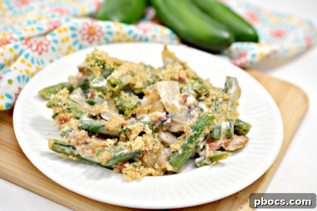 Spicy Keto Jalapeno Popper Green Bean Casserole 3 Close-up of a creamy Keto Jalapeno Popper Green Bean Casserole baking dish, showcasing the rich sauce and fresh green beans