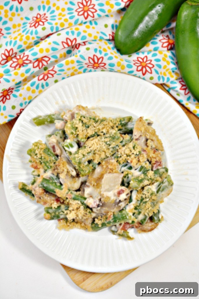 Spicy Keto Jalapeno Popper Green Bean Casserole 5 A close-up of the crispy topping on a Keto Jalapeno Popper Green Bean Casserole, featuring pork rinds and bacon