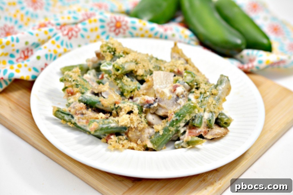 Spicy Keto Jalapeno Popper Green Bean Casserole 6 Side view of Keto Jalapeno Popper Green Bean Casserole, showing layers of creamy sauce and green beans