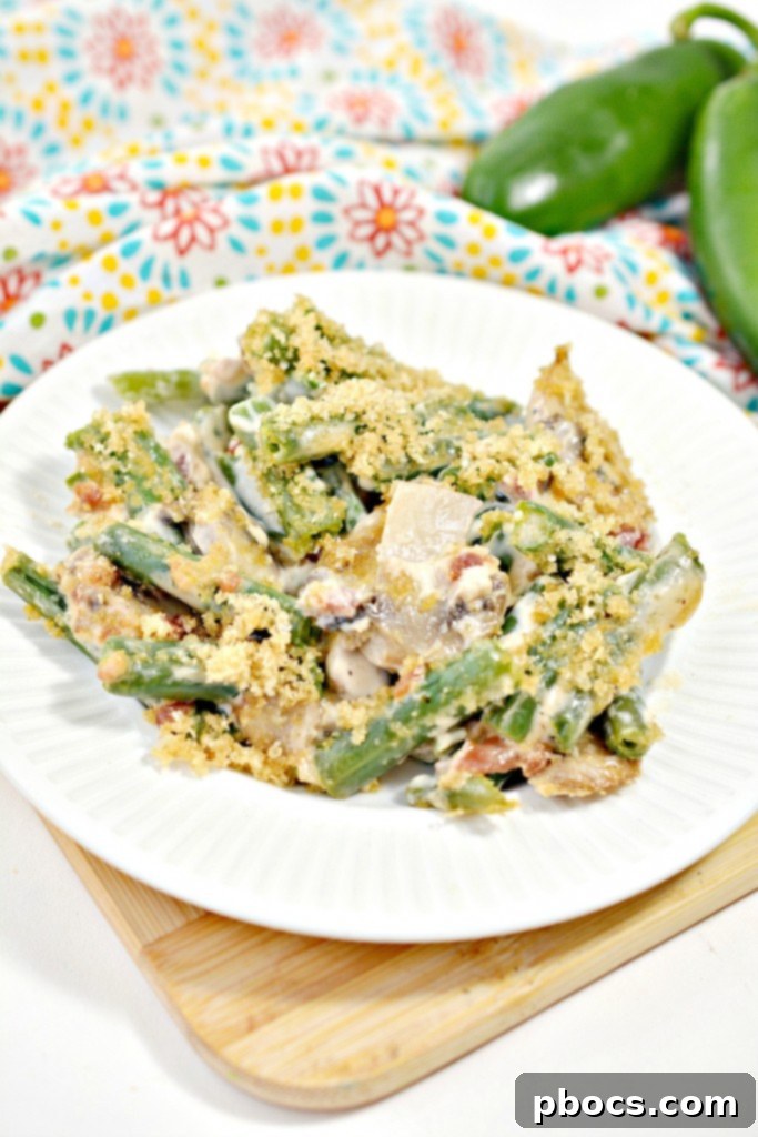 Spicy Keto Jalapeno Popper Green Bean Casserole 7 Serving of Keto Jalapeno Popper Green Bean Casserole on a plate, garnished with fresh herbs, ready to eat